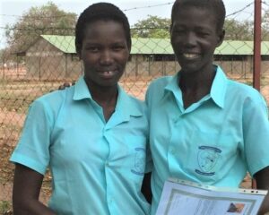 Two of the six female students graduating from the OLSH primary school in Mapuordit this year.